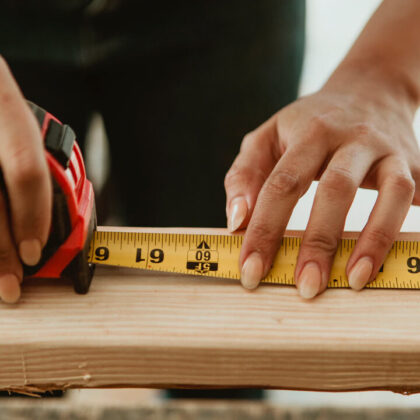 Female carpenter measuring the lumber - Image by © rawpixel